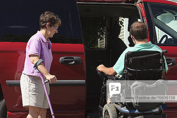Couple with Cerebral Palsy getting into an adaptive vehicle