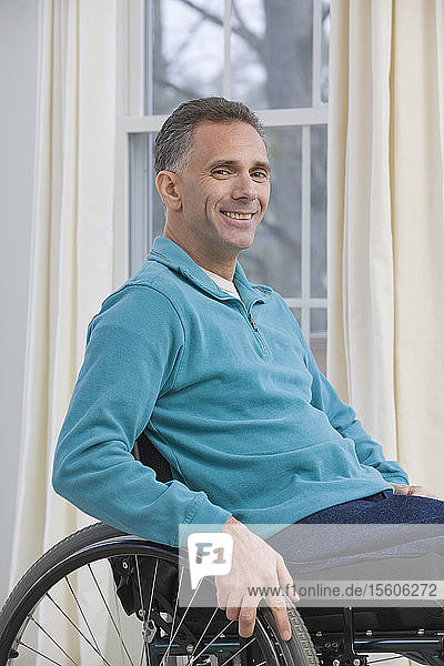 Man sitting in a wheelchair and smiling