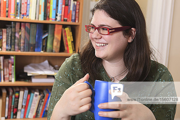 Woman with Asperger's syndrome relaxing with a mug of tea