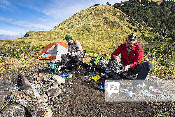 Two backpackers cooking breakfast at their campsite on the Lost Coast