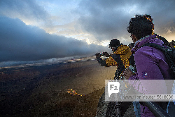 Tourist Taking Picture Of The Sunrise Over Mather Point At Grand Canyon