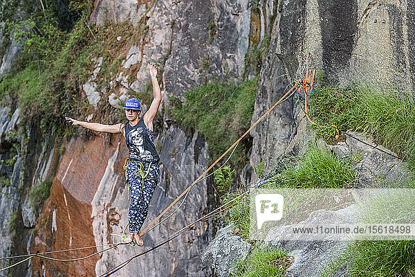 Photograph with adventurous woman standing and balancing on slackline  Dibs Quarry  Maripora  Sao Paulo State  Brazil