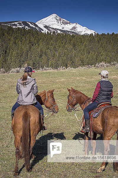 Women ride ranch horses at a Montana guest ranch.
