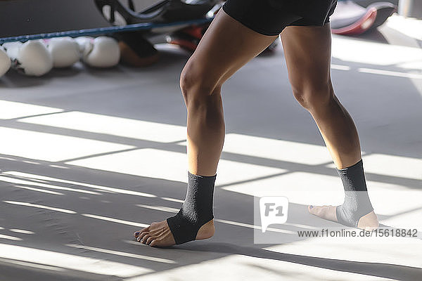 Photograph of young woman's legs in kickboxing stance  Seminyak  Bali  Indonesia