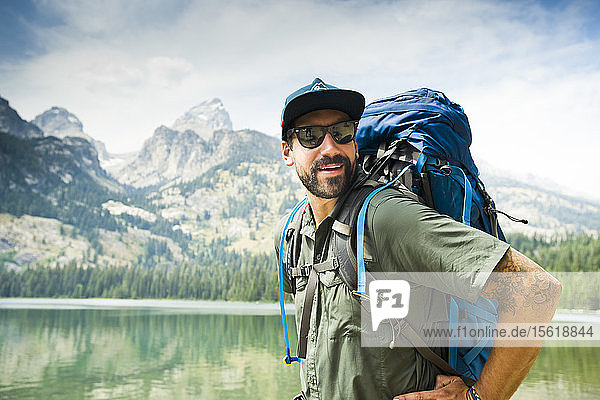 Portrait Of A Backpacker In Front Of The Grand Teton Mountains In Jackson Hole  Wyoming