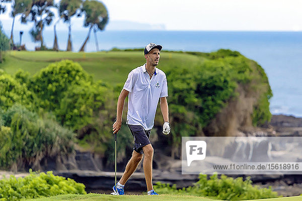 Young man playing golf  Bali  Indonesia