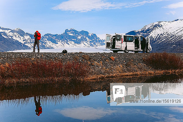 Photographer taking picture near van at Skaftafell  Vatnajokull National Park  Iceland