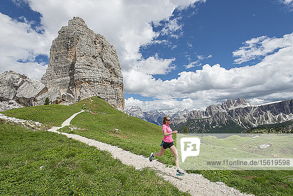 Long Exposure Of Woman Trail Running At The Cinque Torri Area In Dolomites  Italy