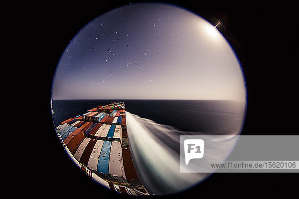 Container ship at sea at night