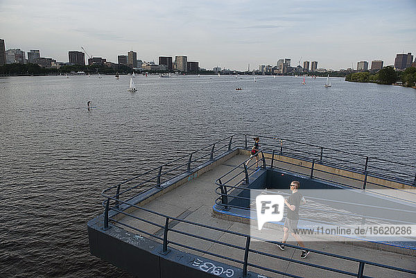View of two runners on bridge along Charles River  Boston  Massachusetts  USA