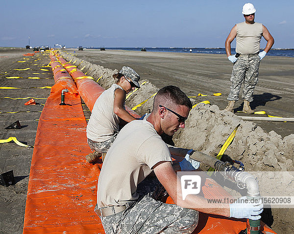 National Guard assembling containment boom to protect Grand Isle State Park beach from oil spill  Grand Isle  Louisiana  USA