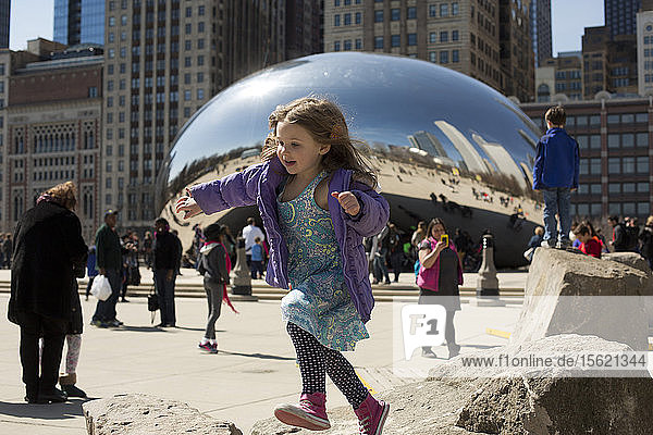 Five year old girl having fun playing near Cloud Gate  Chicago  Illinois  USA