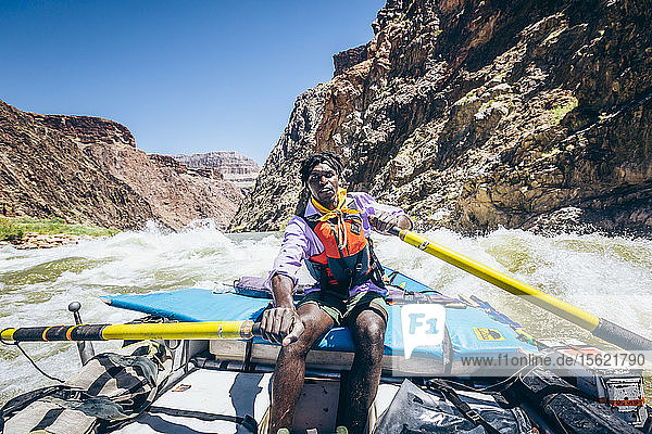 Ein Mann rudert ein Floß durch eine Stromschnelle auf dem Colorado River  Grand Canyon National Park  Arizona  USA