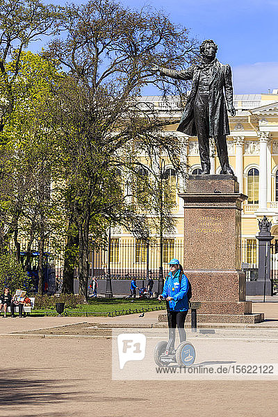 Photograph of woman on Segway near statue of Alexander Pushkin  St. Petersburg  Russia