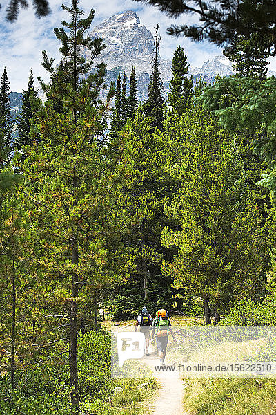 Two Backpacker Hiking At The Grand Teton Mountains In Jackson Hole  Wyoming