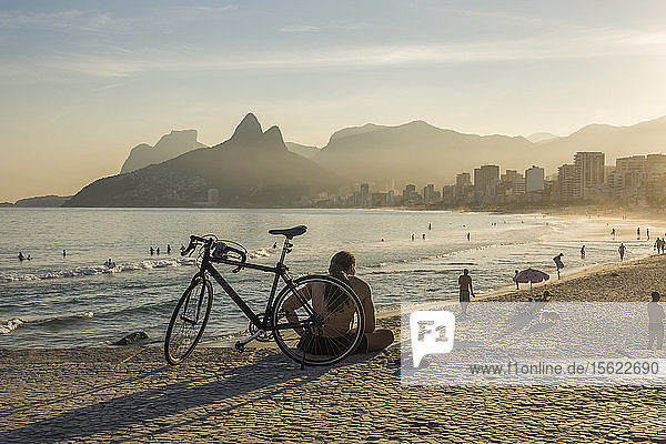 Locals relaxing on sandyï¾ Ipanemaï¾ beach at dusk ï¾ Rioï¾ deï¾ Janeiro  Brazilï¾ 