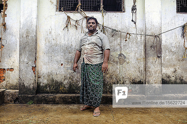 A butcher in front of a butchery Cochin Kerala India.