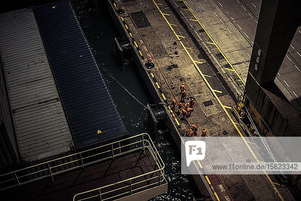 Workers at a container port at night in Singapore