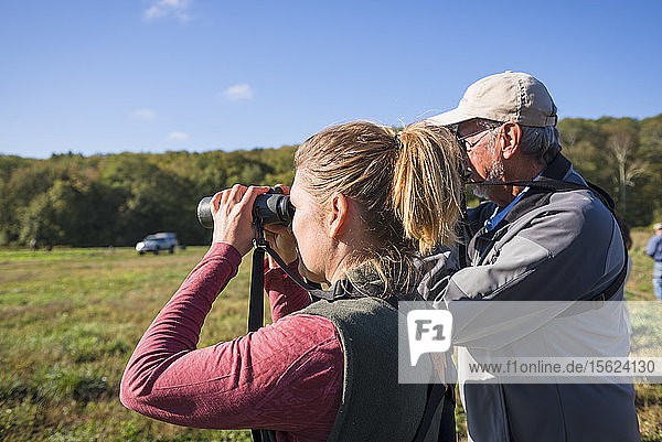 Frau und älterer Mann bei der Vogelbeobachtung mit Ferngläsern mit der Audubon Society  Johnston  Rhode Island  USA