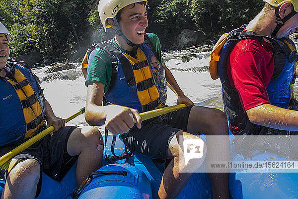Order of the Arrow scouts paddle a raft through flat water and rapids of the New River  during a whitewater adventure in the New River Gorge  near Fayetteville  outside of the Summit Bechtel Reserve  WV.