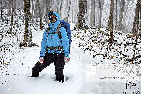 An unpredicted blizzard surprised this Appalachian Trail thru hiker. She can be seen wearing makeshift gloves  Wool socks with ziploc bags pulled over them.