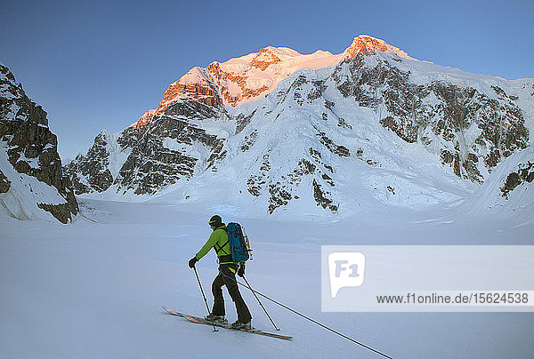 A Ski Mountaineer Is Hiking Over The Kahiltna Glacier In Denali National Park  Alaska