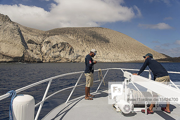 Photograph of two male sailors at bow of ship arriving at San Benedicto Island  Revillagigedo Islands  Colima  Mexico