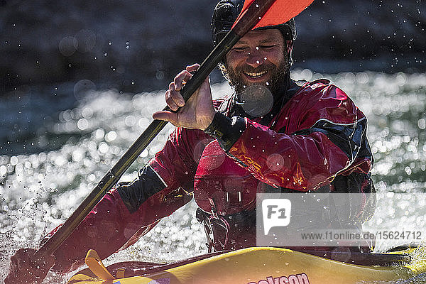 Close up of male kayaker smiling while kayaking on Snake River  Jackson Hole  Wyoming  USA