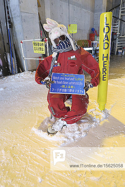 Watch your head and go pro says a sign at the entrance of a ski chair lift in ski resort Niseko  Hokkaido  Japan.