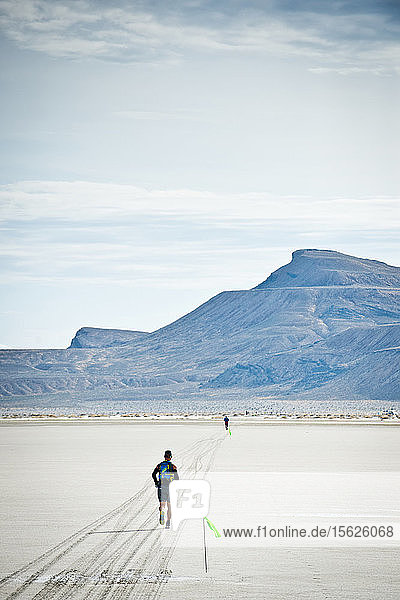 A male athlete runs across the Bonneville Salt Flats during the Salt Flats 100 in Bonneville  Utah.