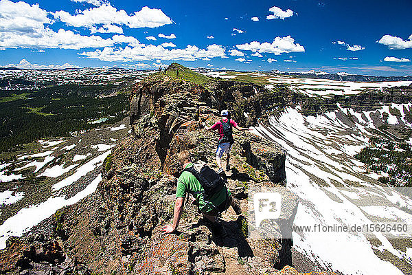Two hikers going across The Devil's Causeway in Yampa  Colorado.