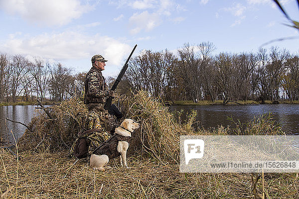 William Shepherd and his hunting dog on a duck hunt along the Mississippi River in western Wisconsin.