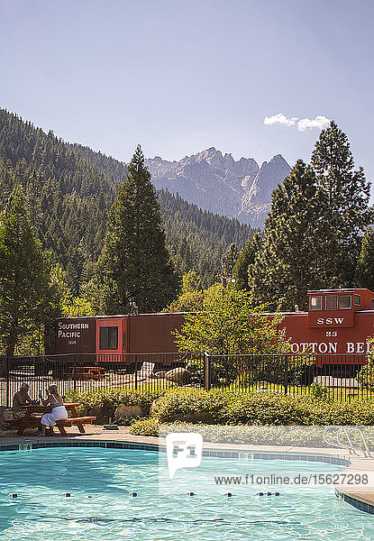 View of swimming pool with train car and mountains in background  Dunsmuir  California  USA