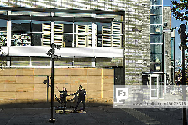 Paar tanzt auf dem Bürgersteig vor einem neu errichteten Gebäude  Seattle  Washington  USA