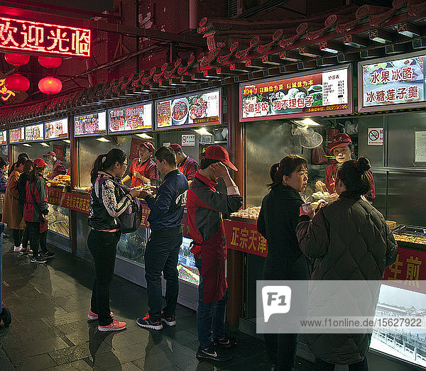 Customers and shops at night market  Beijing  China