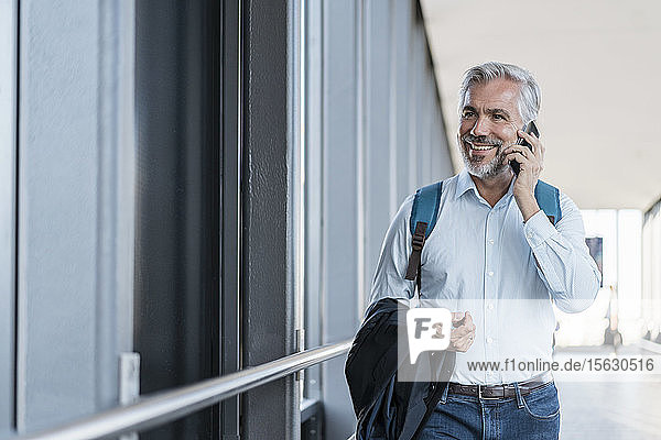 Smiling mature businessman on the phone