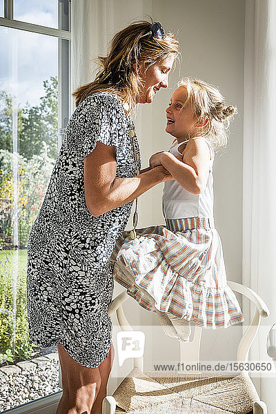 Happy mother with daughter at home