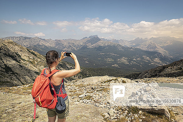 Female hiker during hike  photographing with her viewpoint  Haute-Corse  Corsica  France