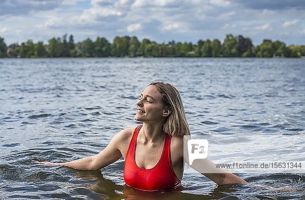 Smiling woman bathing in a lake