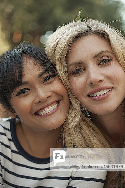 Close up portrait of two smiling women