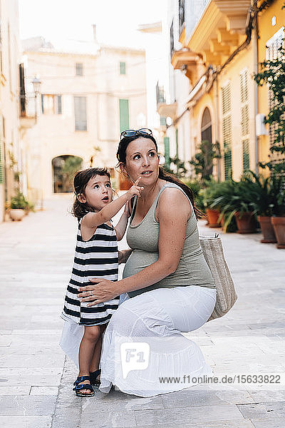 Portrait of mother and little daughter watching something  Alcudia  Mallorca  Spain