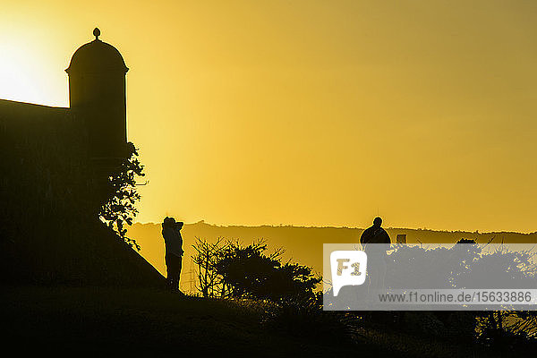 Silhouette tourists standing by Fortaleza San Felipe against clear sky at sunset  Puerto Plata  Dominican Republic