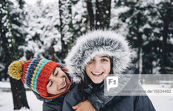 Portrait of happy young couple in winter forest