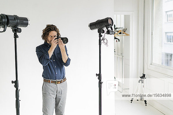 Photographer taking pictures in his studio
