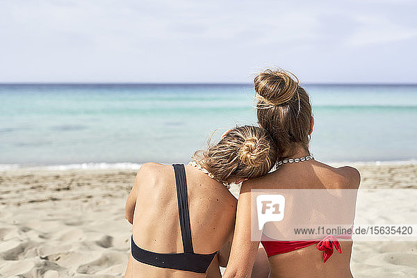 Rear view of two young women on a beach