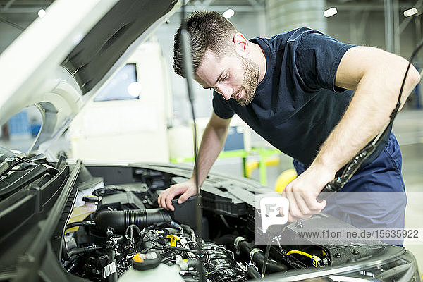 Man working on car in modern factory