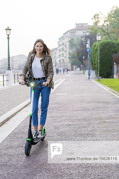 Young woman with e-scooter in Verona  Italy