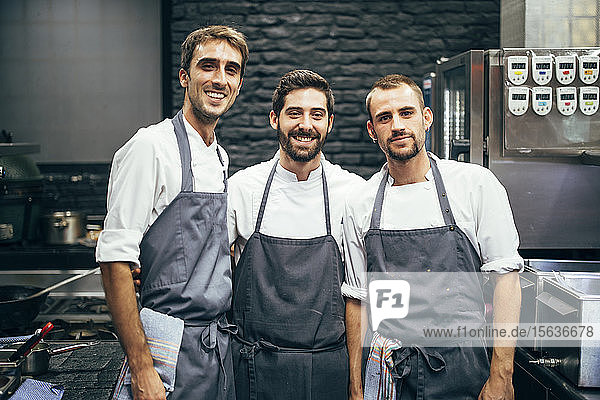 Portrait of three cooks in the kitchen of a restaurant