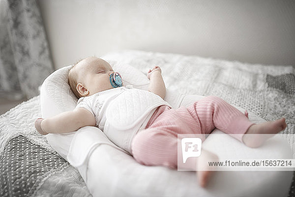 Cute baby girl sleeping on the bed