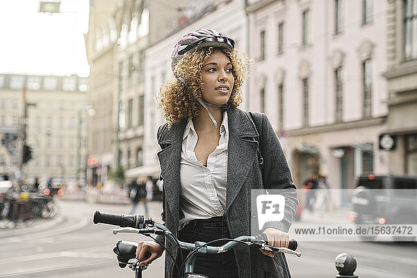 Woman with bicycle in the city  Berlin  Germany